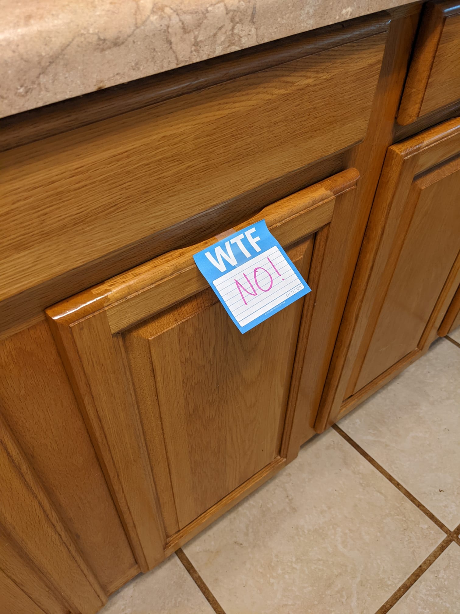 front of a row of cabinets with a sticky note that says NO!