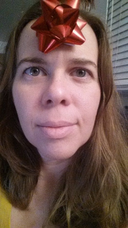 selfie of a person with a gift bow on her forehead