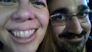 very close selfie of two peoples faces in partial darkness