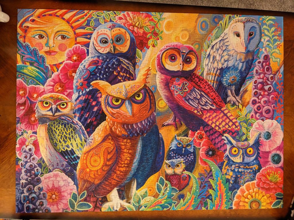 a finished puzzle of an image of many owls in a stylized artistic interpretation