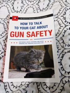 a book with a kitten on the cover title: How to talk to your cat about gun safety