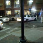 a night street corner scene with many cop cars