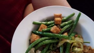 a bowl of fried green beans and tofu