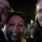 a blurry and dark selfie of three people laughing
