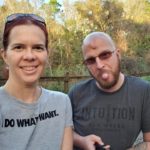 a selfie of two people in the woods