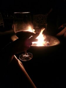 silhouette of a wine glass in front of a fire