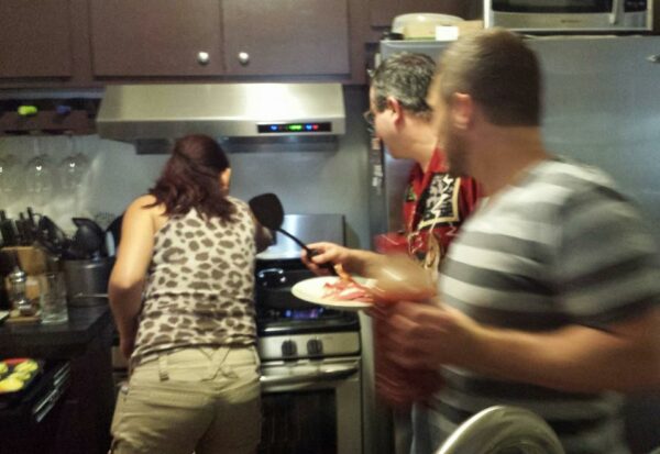 a blurry shot of a group of people in a kitchen cooking