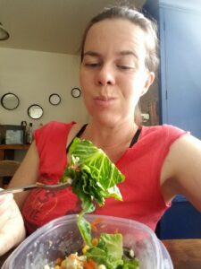 selfie eating salad and looking comically unconcerned