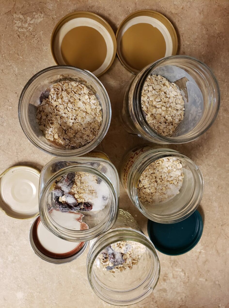 looking down at five slightly different size jars with oatmeal in them