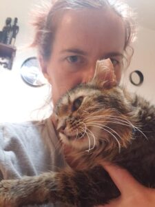 selfie holding a fluffy but old cat near my face