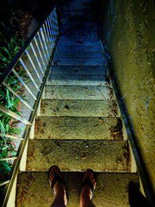dramatically lit stairwell with the steps shading from yellow to deep blue