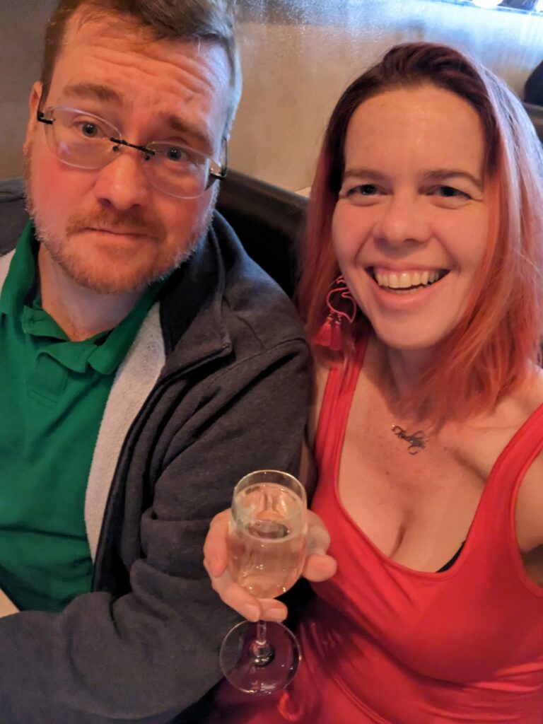 a selfie in a red dress next to a person in a hoodie and a polo