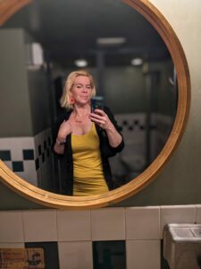 selfie in a yellow dress in a round mirror