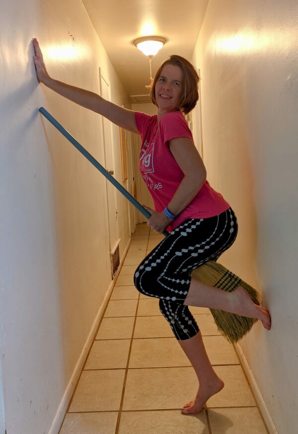 selfie in a hallway with a broom like a witch