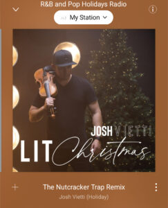 screenshot of a music album for Lit Christmas by Josh Vietti showing a man holding a violin up and the title Nutcracker Trap Remix