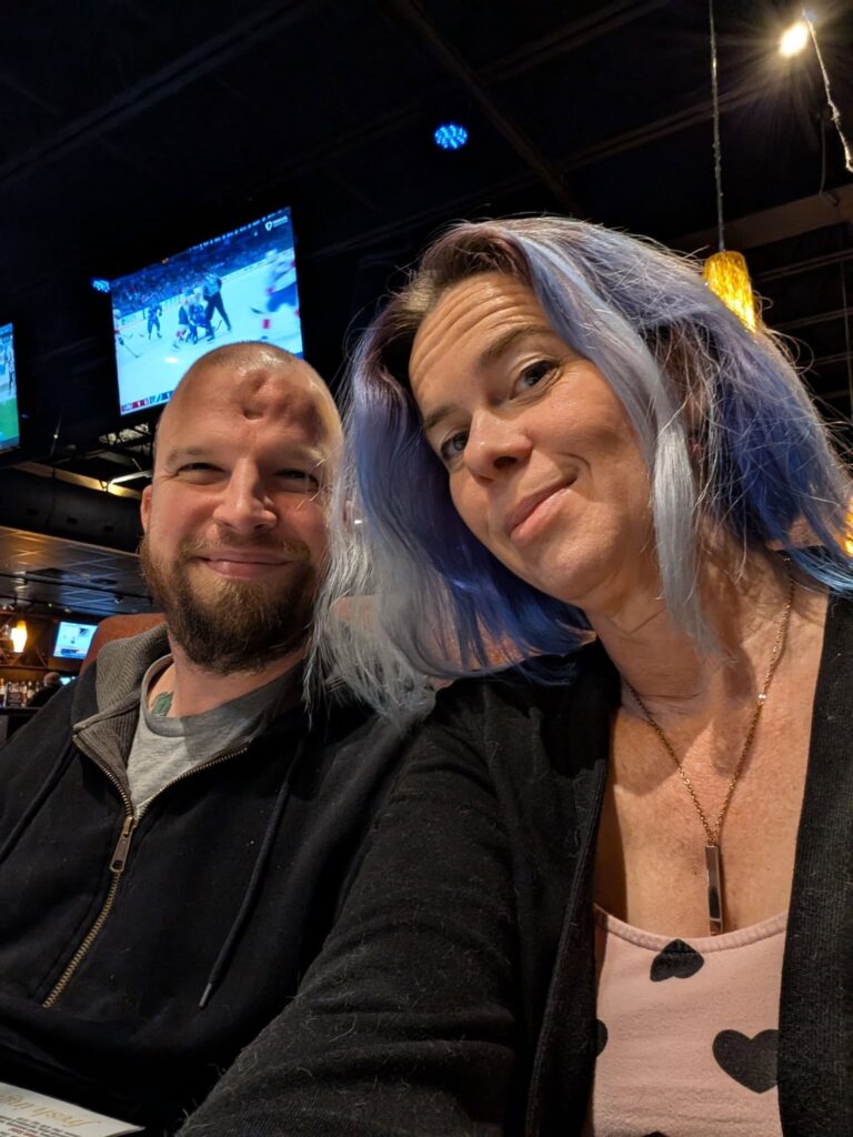selfie of two people at some kind of bar of restaurant