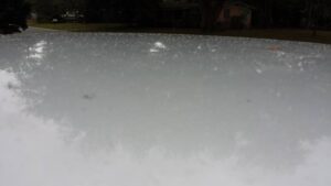 a large smooth and somewhat curved surface that might be reflective and is sprinkled with with grit
