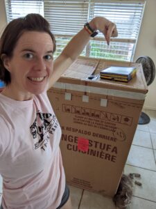 a person is pointing down at a very large cardboard box