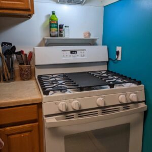 a stove in a kitchen looks somewhat new and clean