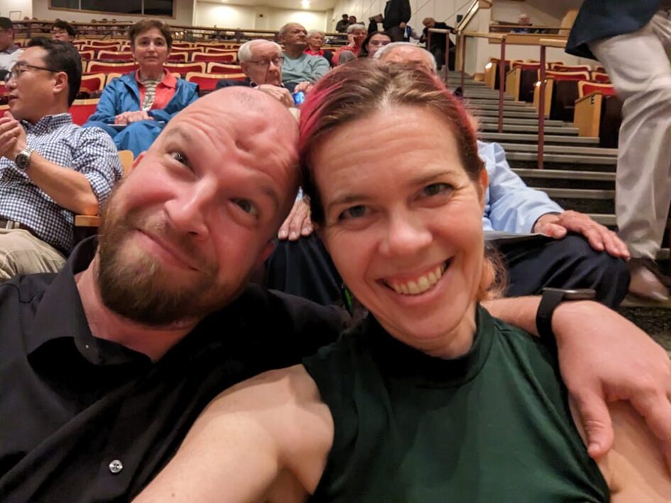 selfie of two people in a theater of some kind