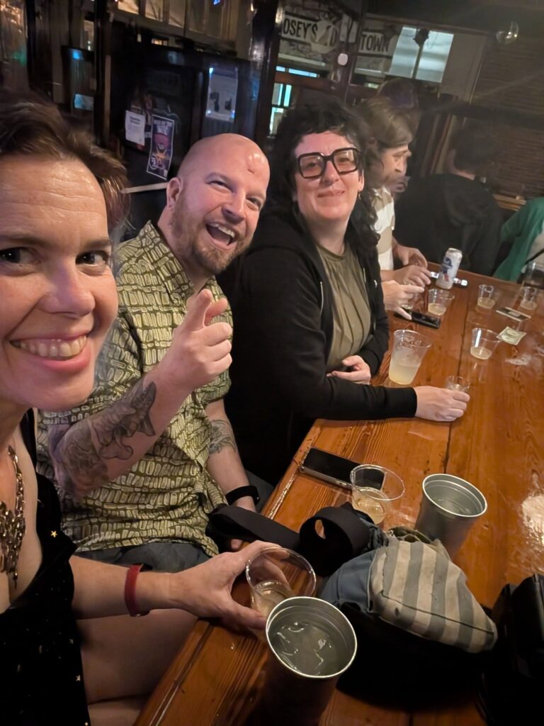 several people are sitting along a bar