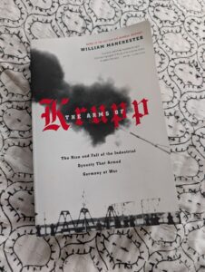 the cover of a book in black and white with the word Krupp in ornate red letters and a little white text over saying 'The arms of' and text below saying The rise and fall of the industrial dynasty that armed Germany at war.