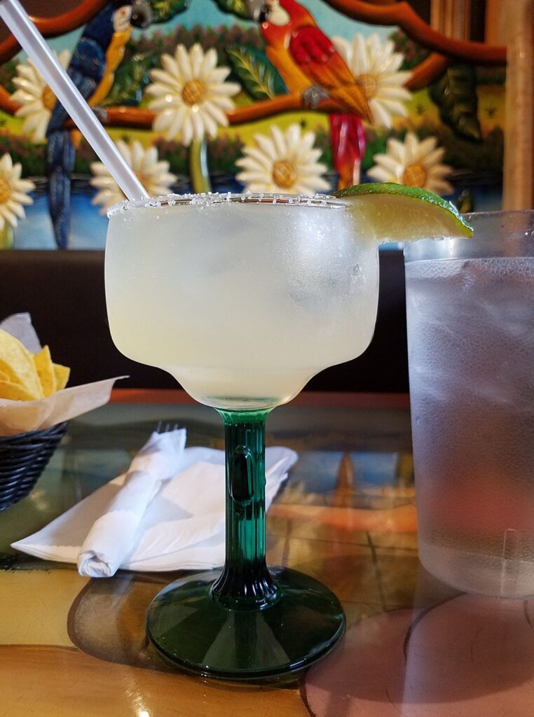 a margarita glass with a colorful floral background