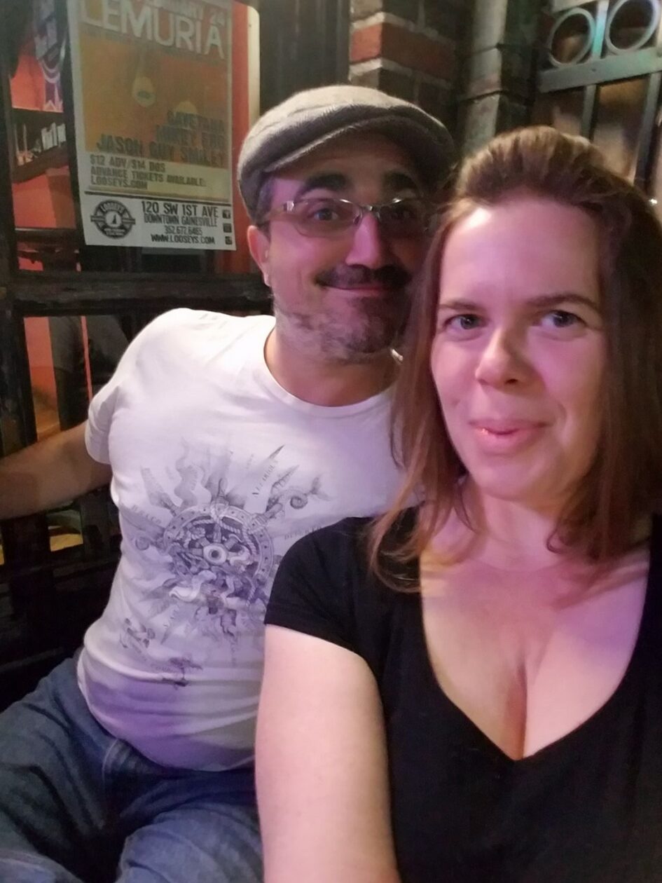 two people taking a selfie at what looks like a bar or pub