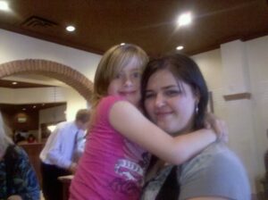 a very blurry picture of an adult and a child hugging and making faces