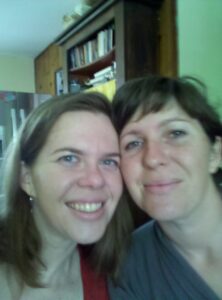 selfie of two women smiling at the camera looking exhausted