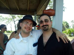 two people in semiformal clothing have their arms around each other's shoulders