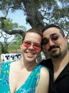a selfie of two people wearing sunglasses in some kind of park