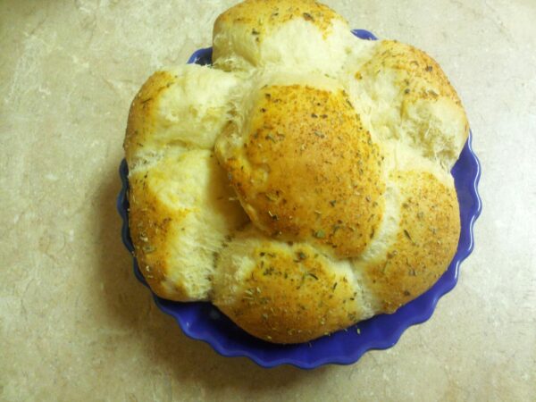 looking down at a loaf of bread in a blue dish