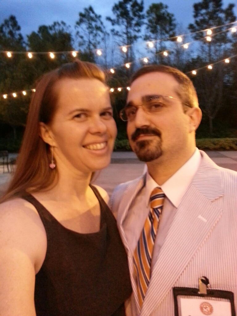 two people in formal wear are posing for a selfie