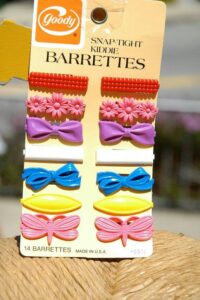 a card with Goody brand barrettes have pairs of brightly colored plastic barrettes clipped down each side