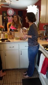 two people standing in a kitchen talking