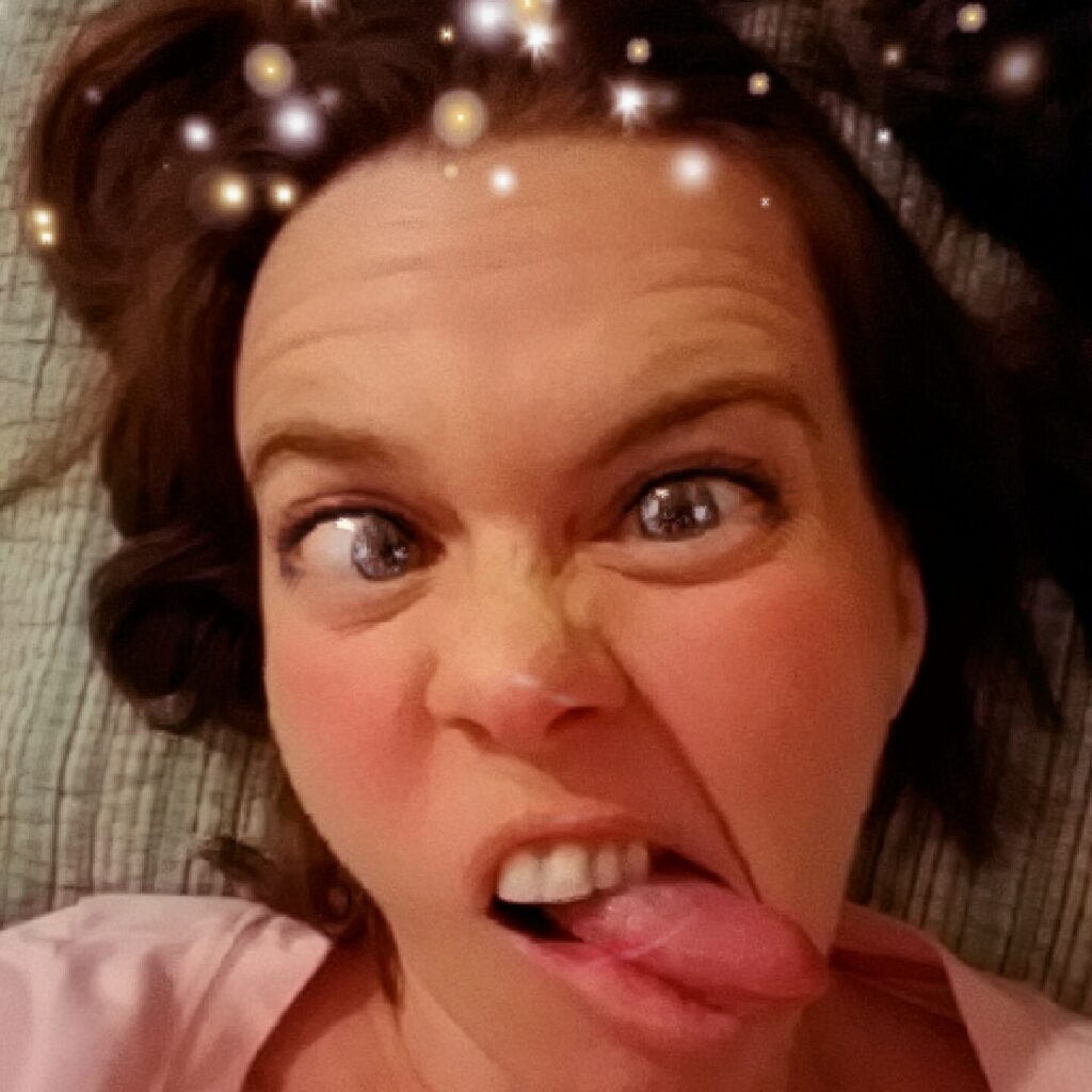 a selfie of a person making a face with a filter that makes their eyes look like cartoons and adds sparkles in their hair