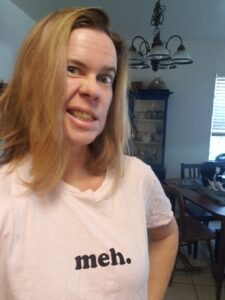 selfie of a person wearing a shirt that says meh