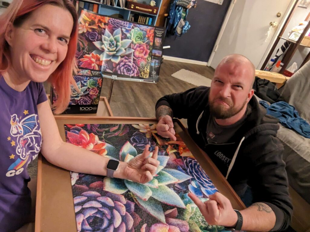 people on either side of a puzzle are making faces at the camera