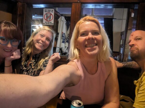 a crowded selfie of four people in a restaurant