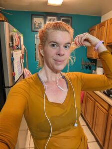 a selfie of a person in a kitchen with a wet shirt on