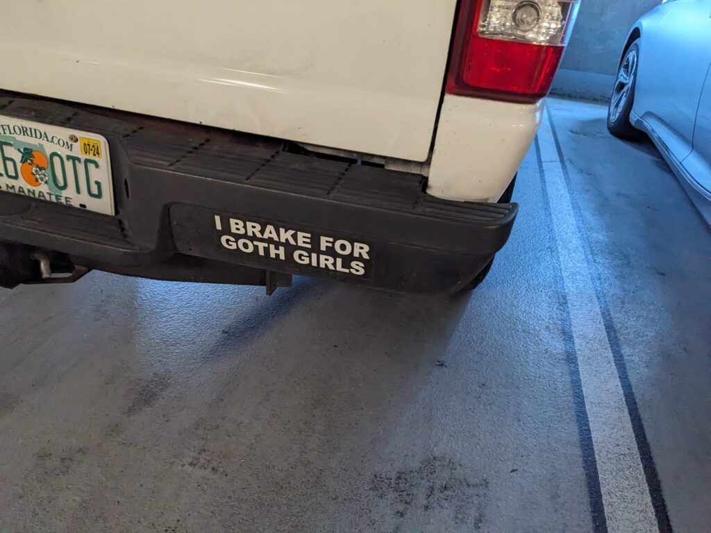 a truck bumper sticker says I Brake For Goth Girls