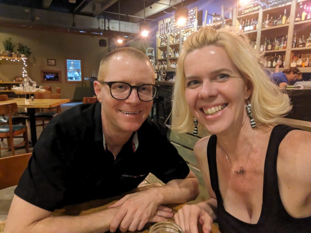 selfie of two people at a restaurant smiling into the camera