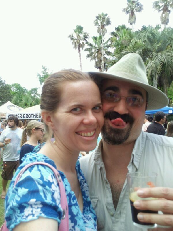 selfie of two people at what looks like an outdoors beer event