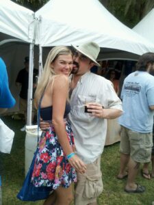two people are posing for a photo with one acting like he's putting his tongue in her ear
