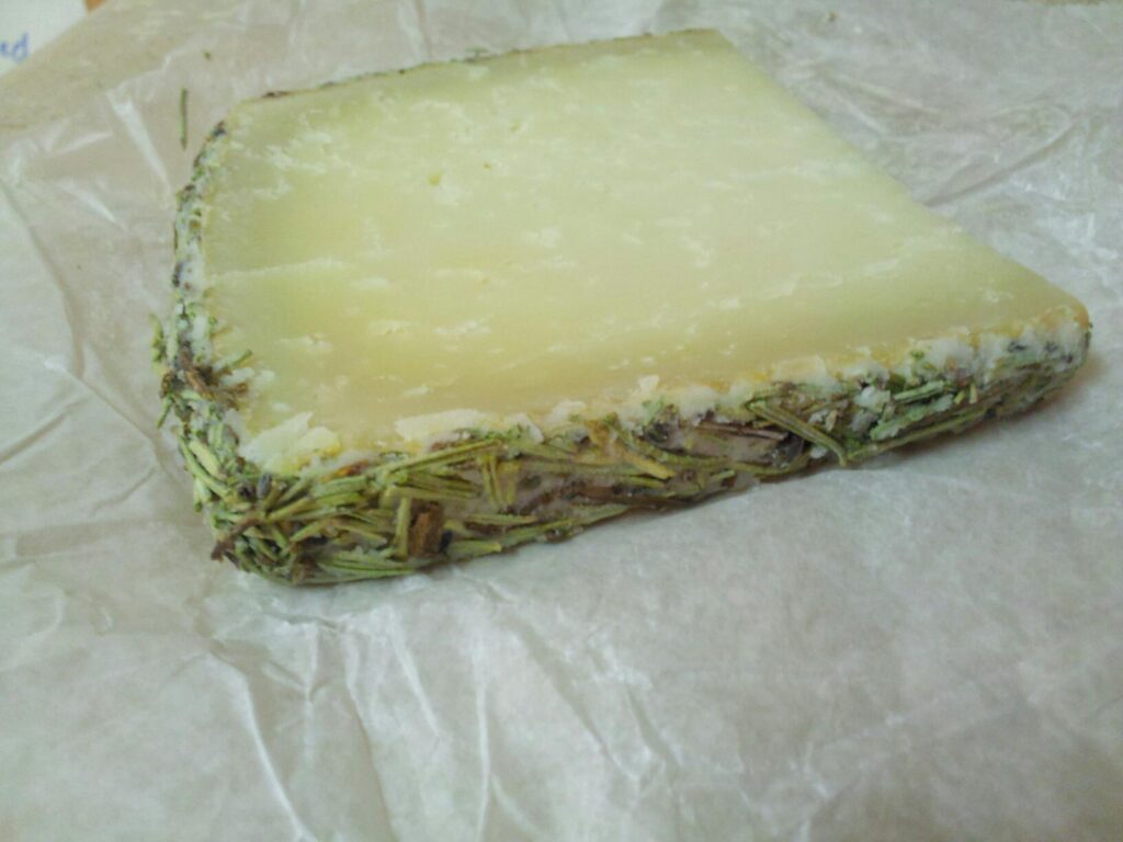 a thin wedge of cheese crusted with rosemary