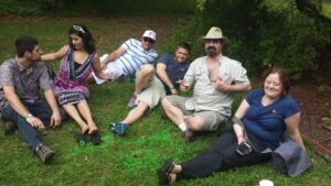 six people are sitting on a lawn