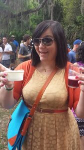 a person holds up two containers and smiles for a photo