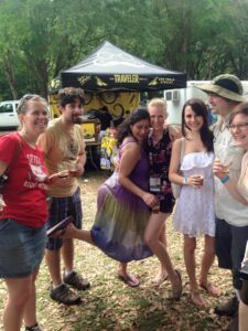 a group of people are posing for a photo at an outdoors event surrounded by beer tents