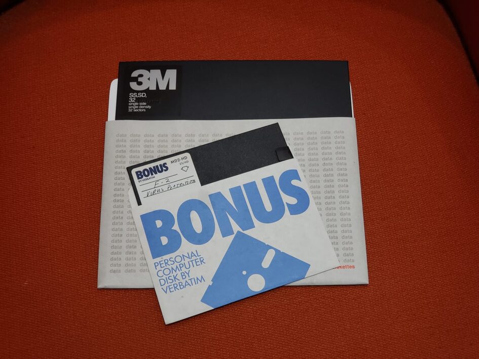 a large floppy disc and a smaller floppy disk